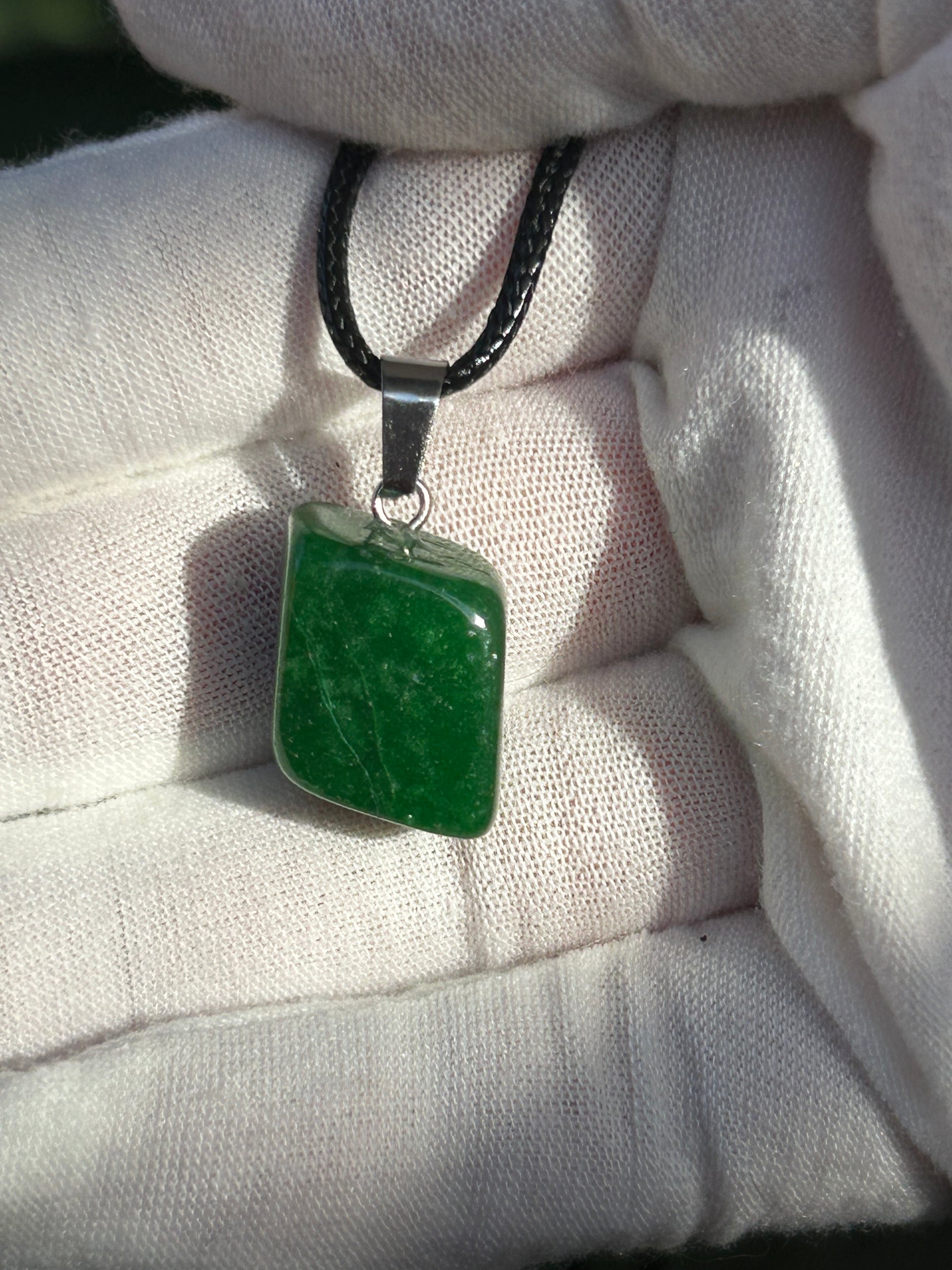 Green Aventurine polished pendant with silver pendant attachment and black cord necklace