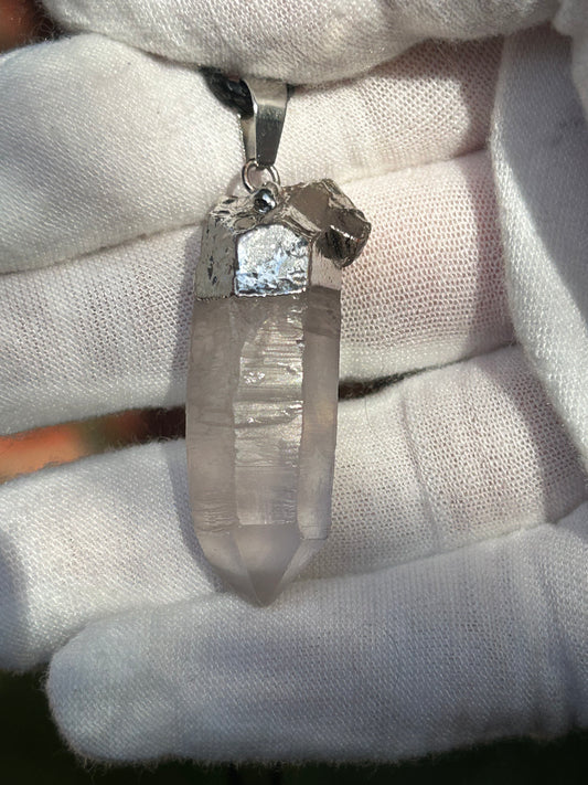 Clear quartz shard pendant with silver top and pendant attachment and black cord necklace