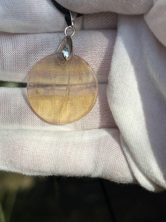 Rainbow Fluorite Circular Pendant with silver pendant attachment and black cord necklace