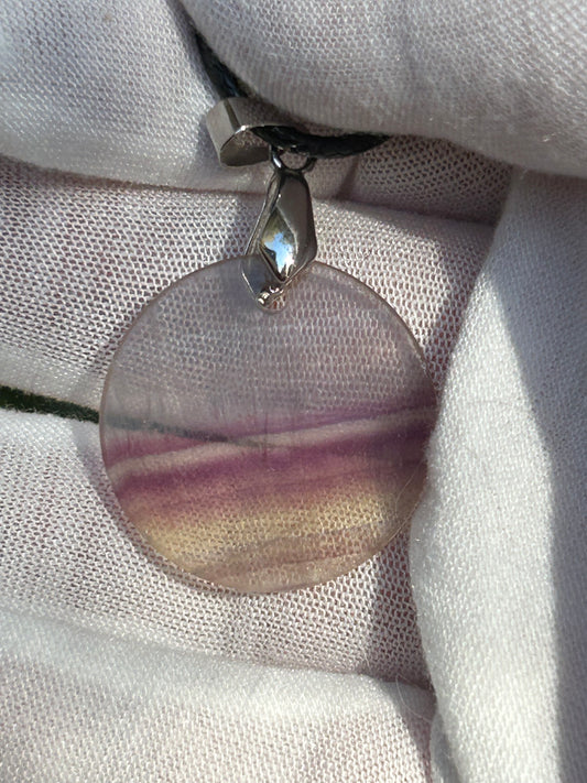 Rainbow Fluorite Circular Pendant with silver pendant attachment and black cord necklace