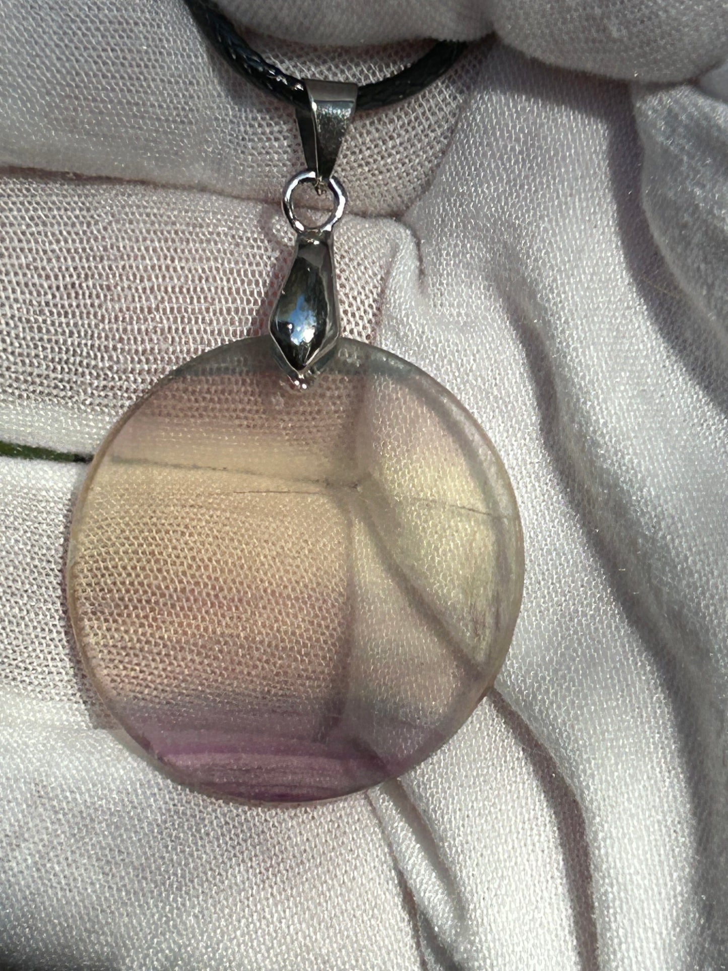 Rainbow Fluorite Circular Pendant with silver pendant attachment and black cord necklace