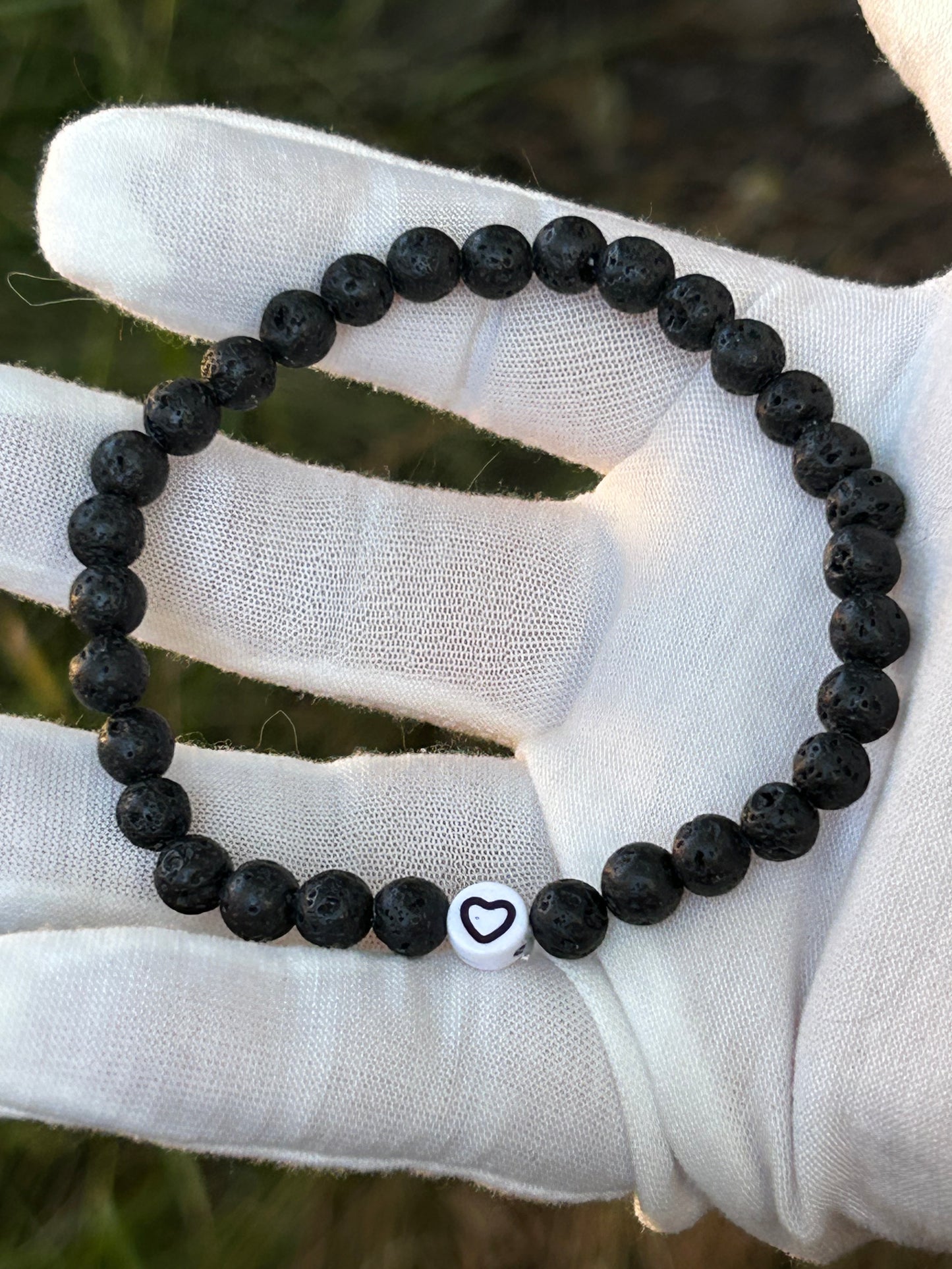 black lava rock bead bracelet with heart emblem