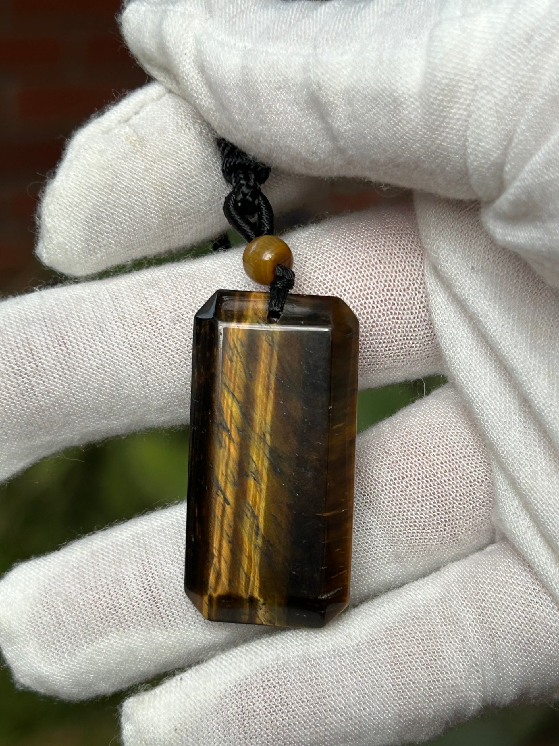 rectangular tiger eye pendant with black cord necklace