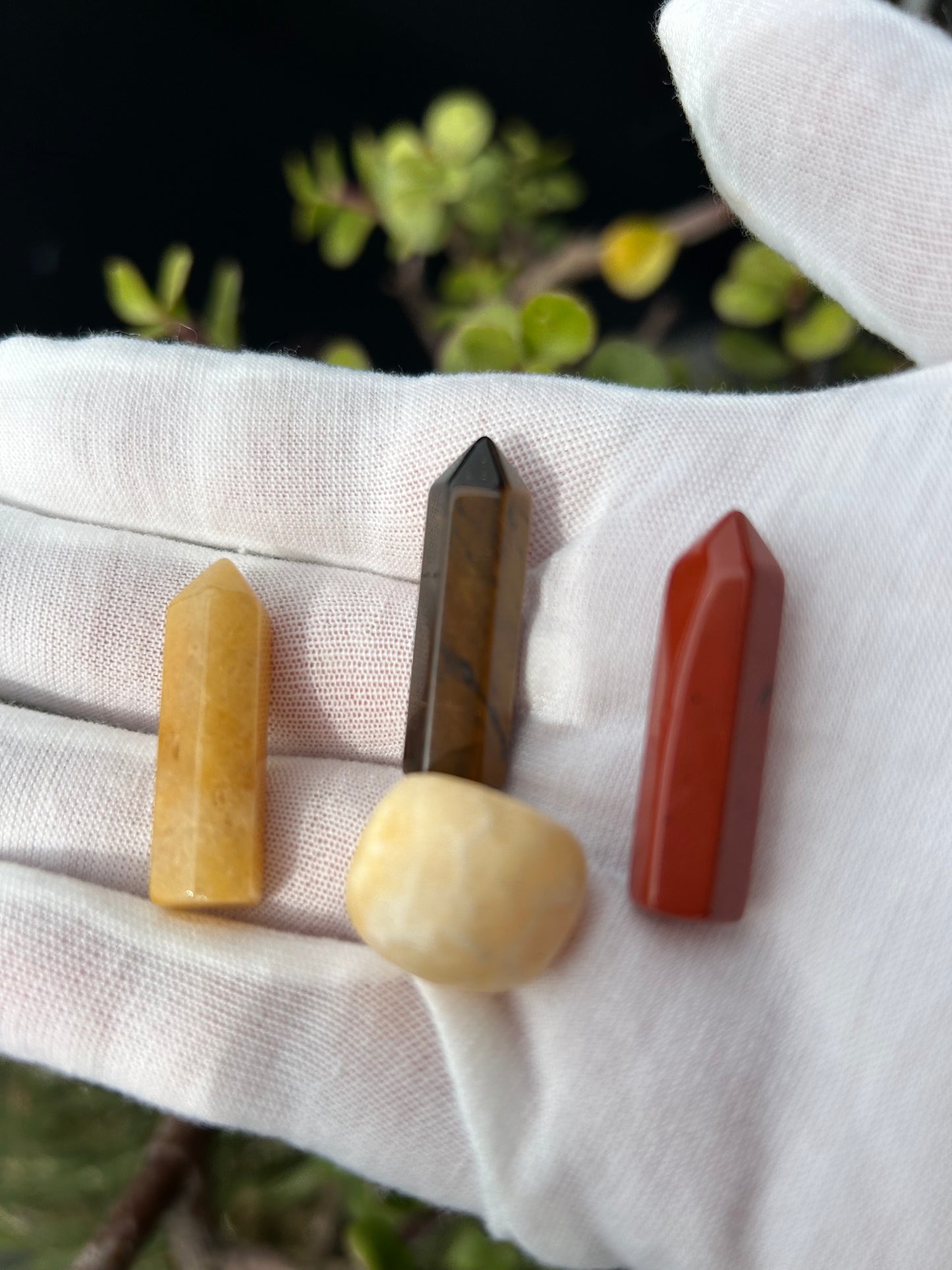 Orange Calcite polished stone, topaz jade point, tigers eye point and red jasper point.