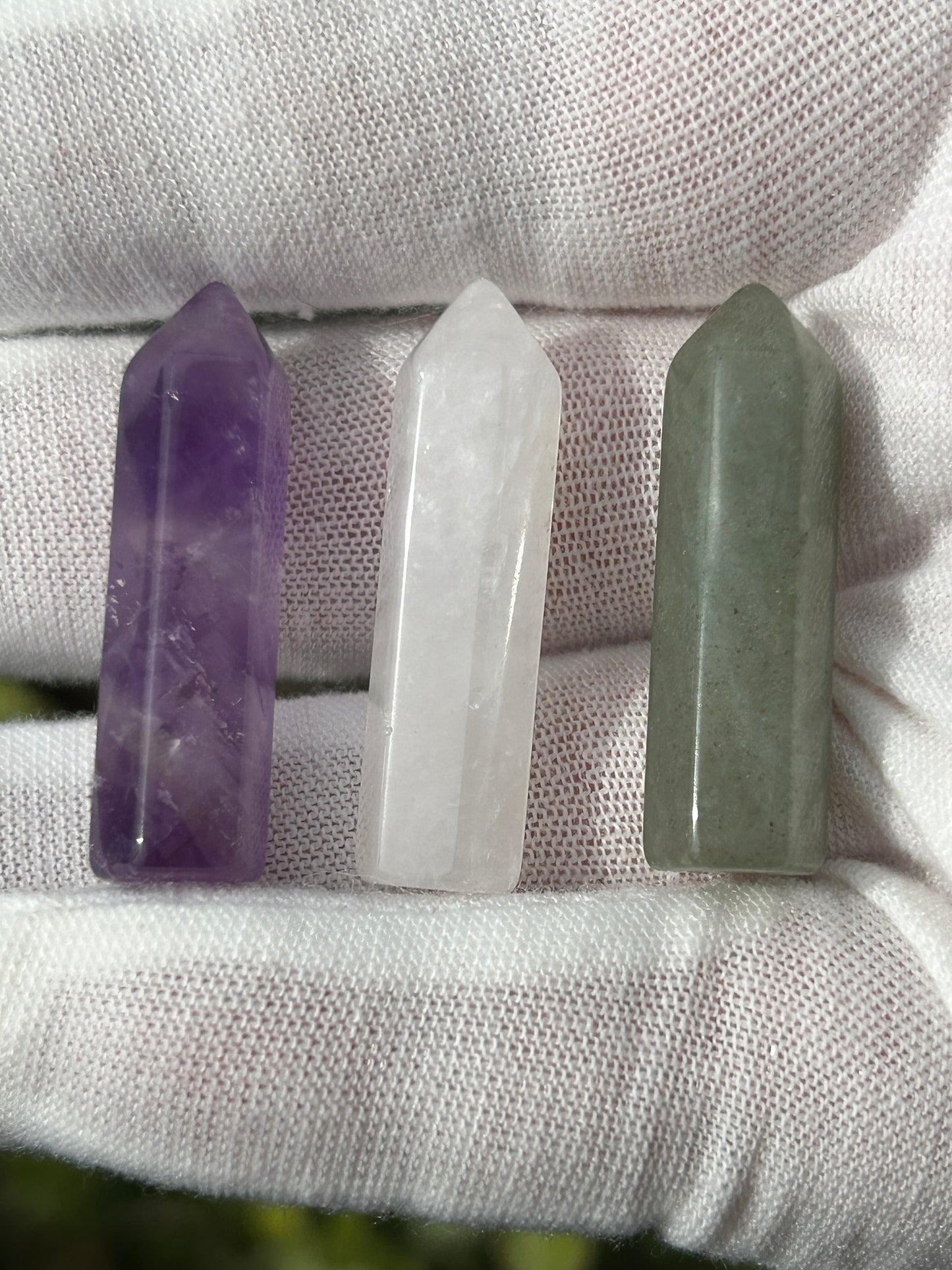 Amethyst point, clear quartz point and a green aventurine point.