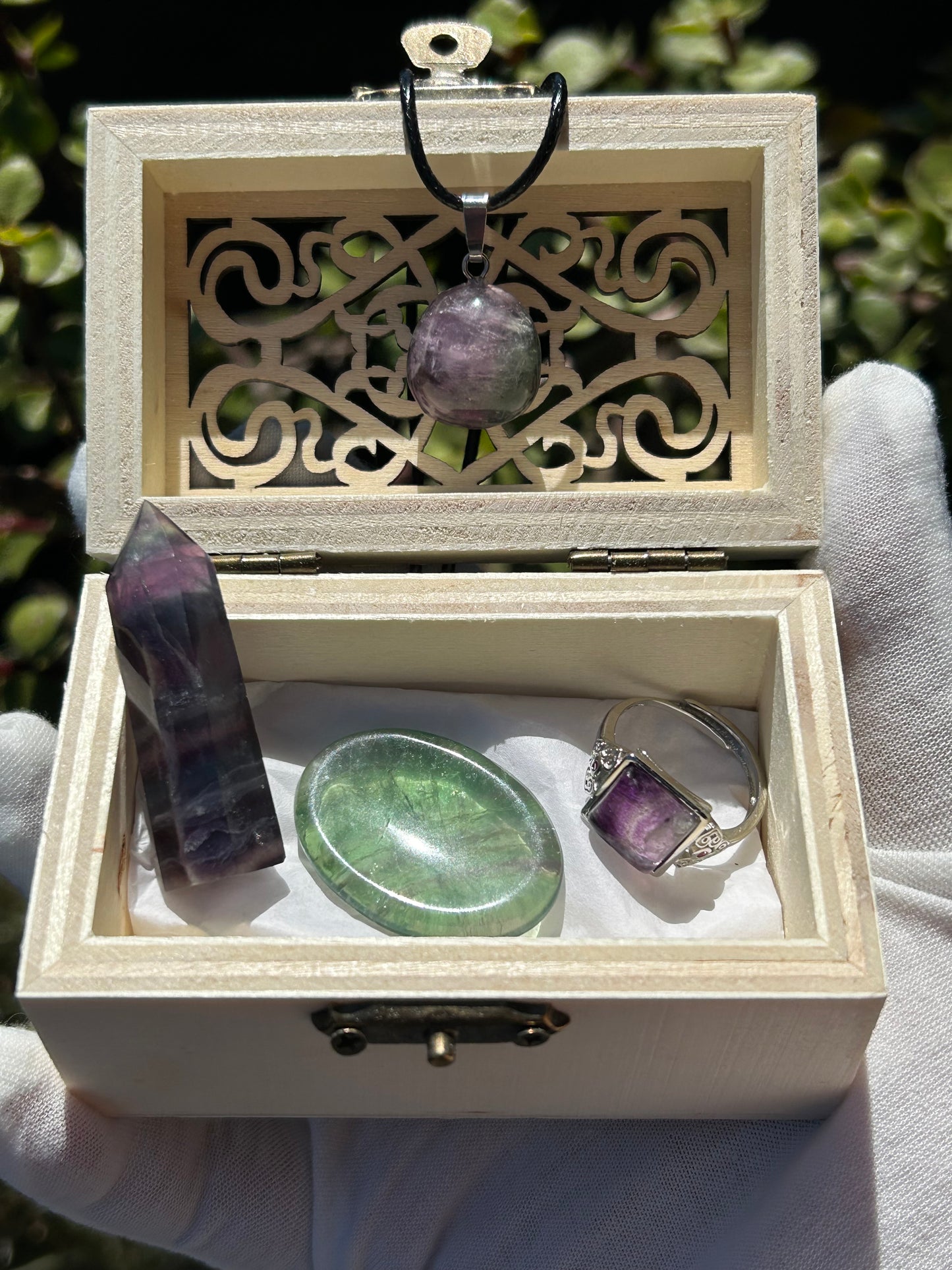 wooden treasure chest with rainbow fluorite pendant, rainbow fluorite point, green fluorite palm stone, purple fluorite adjustable ring.