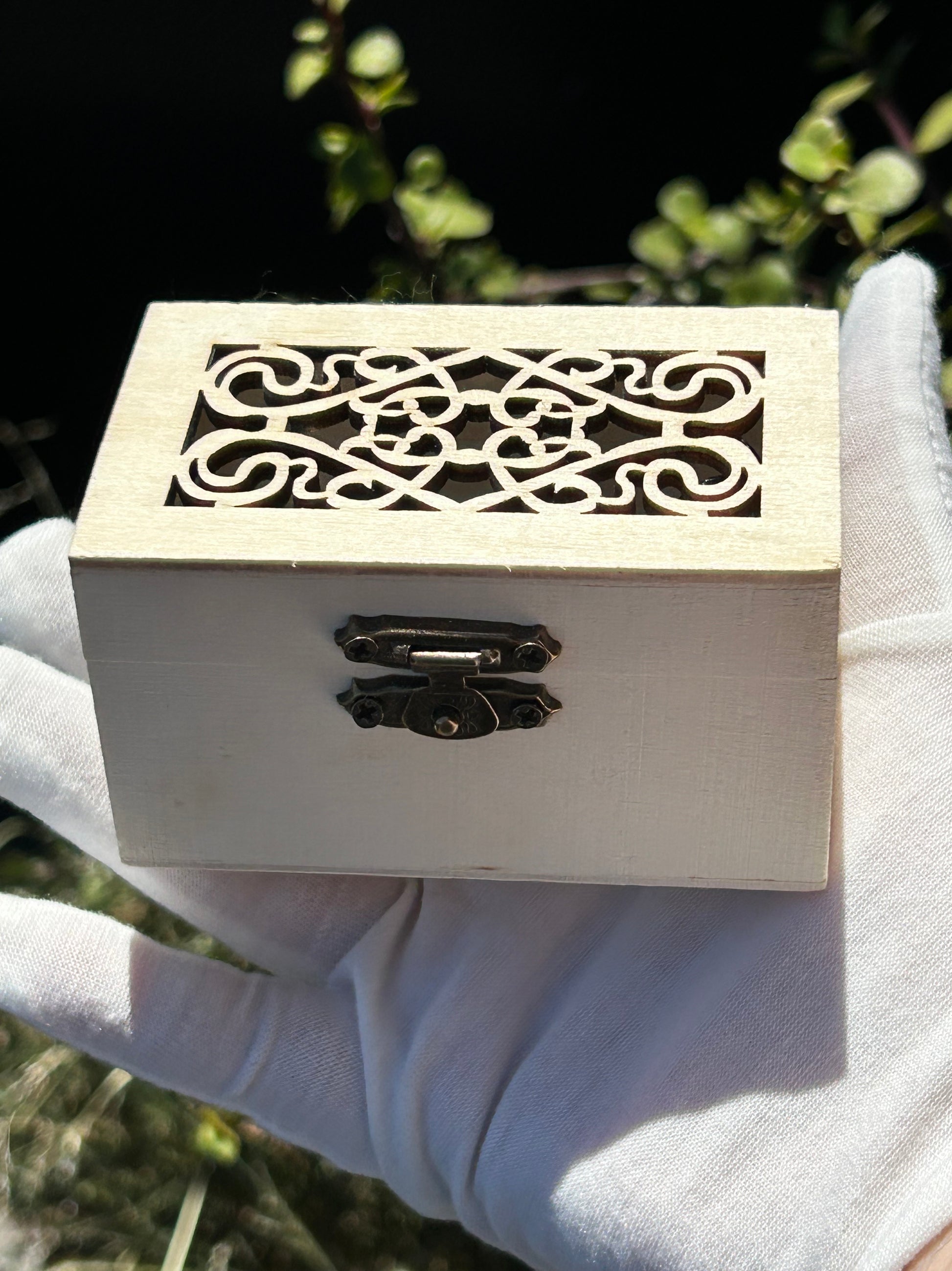 Wooden treasure chest with intricate cutout design on the lid